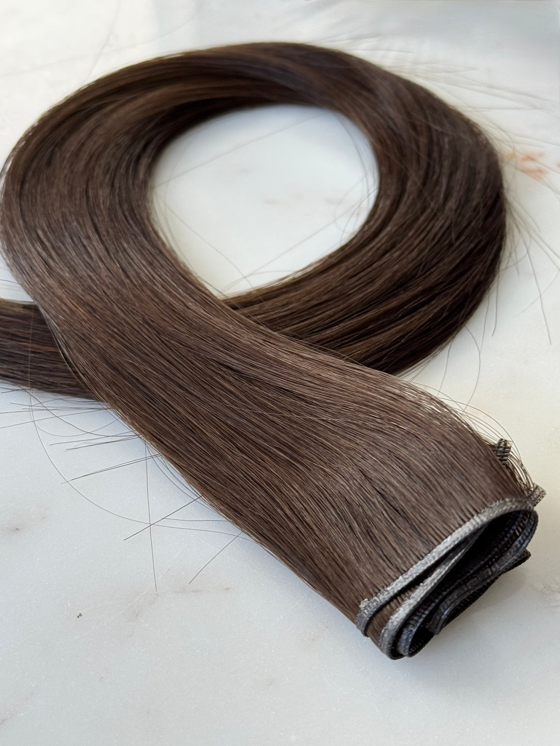 Warm blonde Genius Weft hair extensions