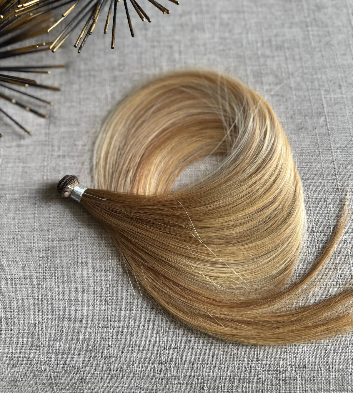 Amanda Bronde hand tied hair weft showing blended brown and blonde tones