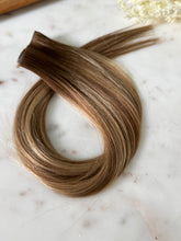Load image into Gallery viewer, Close view of the Amanda warm bronde hybrid hair extension weft color and texture
