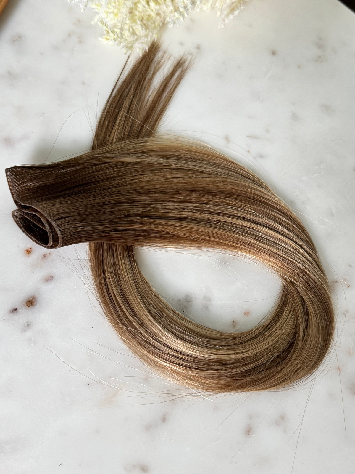 Amanda warm bronde hybrid hair extension weft arranged in a centered full product view
