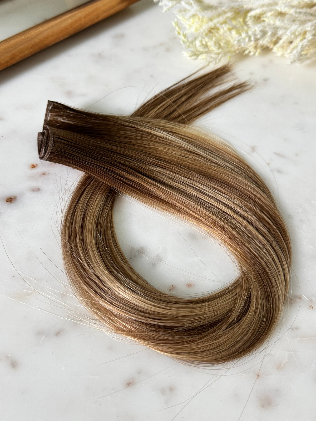 Amanda warm bronde hybrid hair extension weft with the layered seam visible