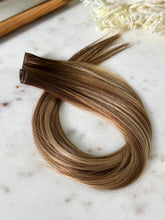 Load image into Gallery viewer, Amanda warm bronde hybrid hair extension weft with the layered seam visible