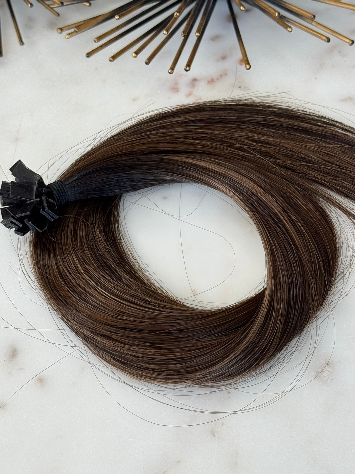 Bree cool brunette K-tip hair extensions arranged in a centered full product view
