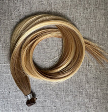 Load image into Gallery viewer, Brooke hand tied hair extension in a warm bronde blend, coiled front view