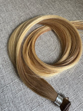 Load image into Gallery viewer, Brooke hand tied hair extension in a warm bronde blend with hand tied weft detail