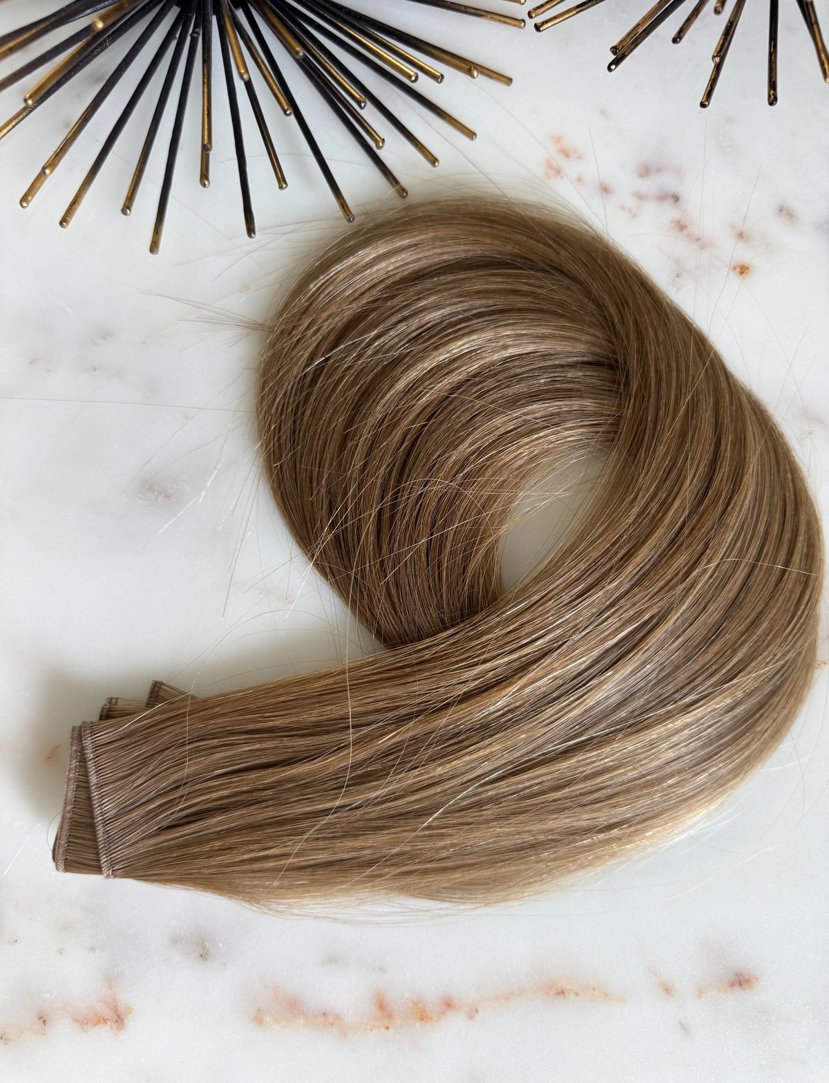 Chai hybrid weft in a dirty blonde shade, coiled angled view
