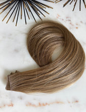Load image into Gallery viewer, Chai hybrid weft in a dirty blonde shade, coiled angled view
