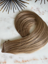 Load image into Gallery viewer, Chai hybrid weft in a dirty blonde shade, coiled front view