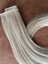 Load image into Gallery viewer, Champagne hybrid weft close-up of the seam and hair texture