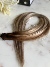 Load image into Gallery viewer, Darcie 22-inch hybrid weft hair extensions photographed from a side angle