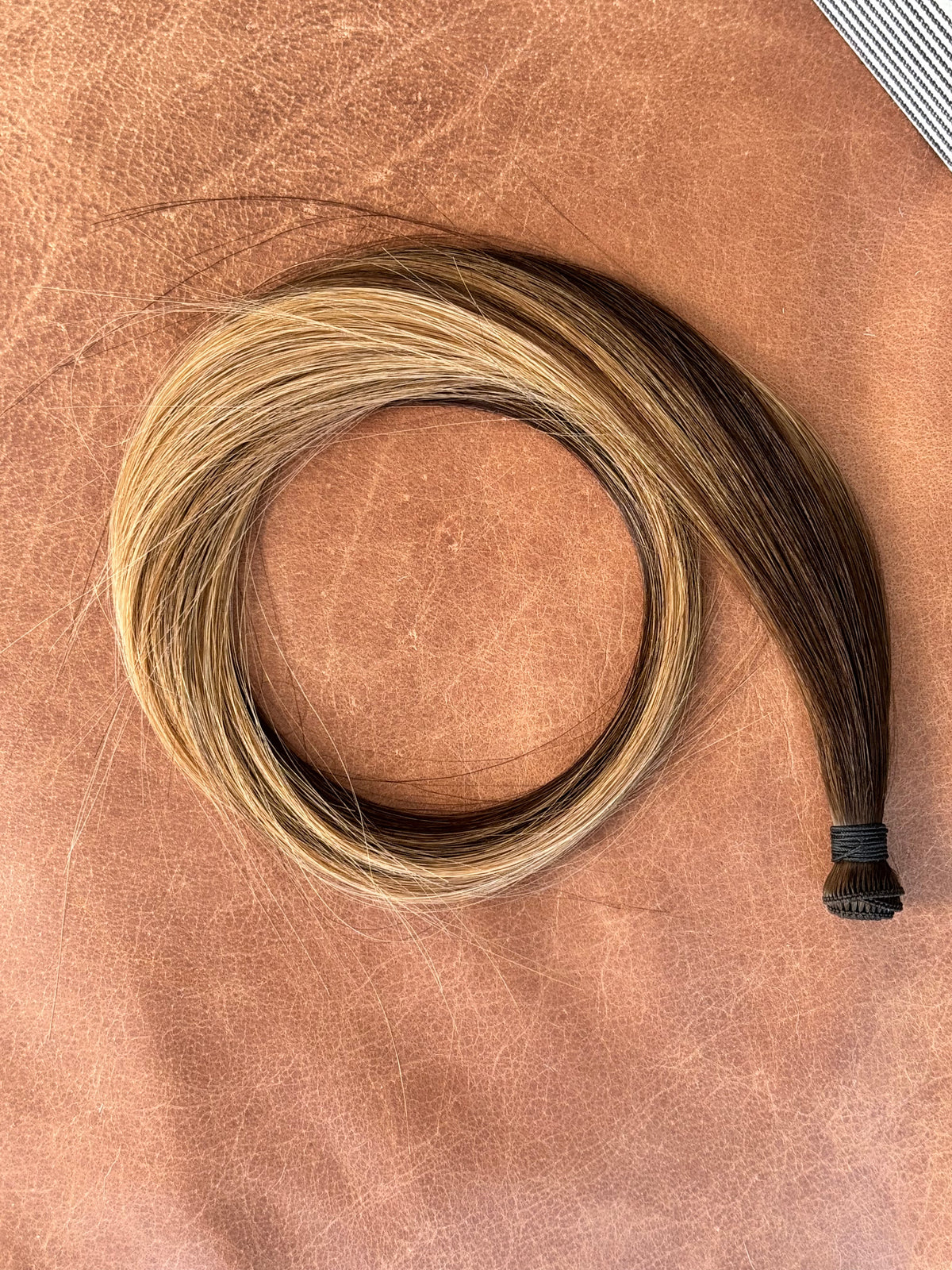 Kallee hand tied hair weft overhead view showing the brunette and blonde blend