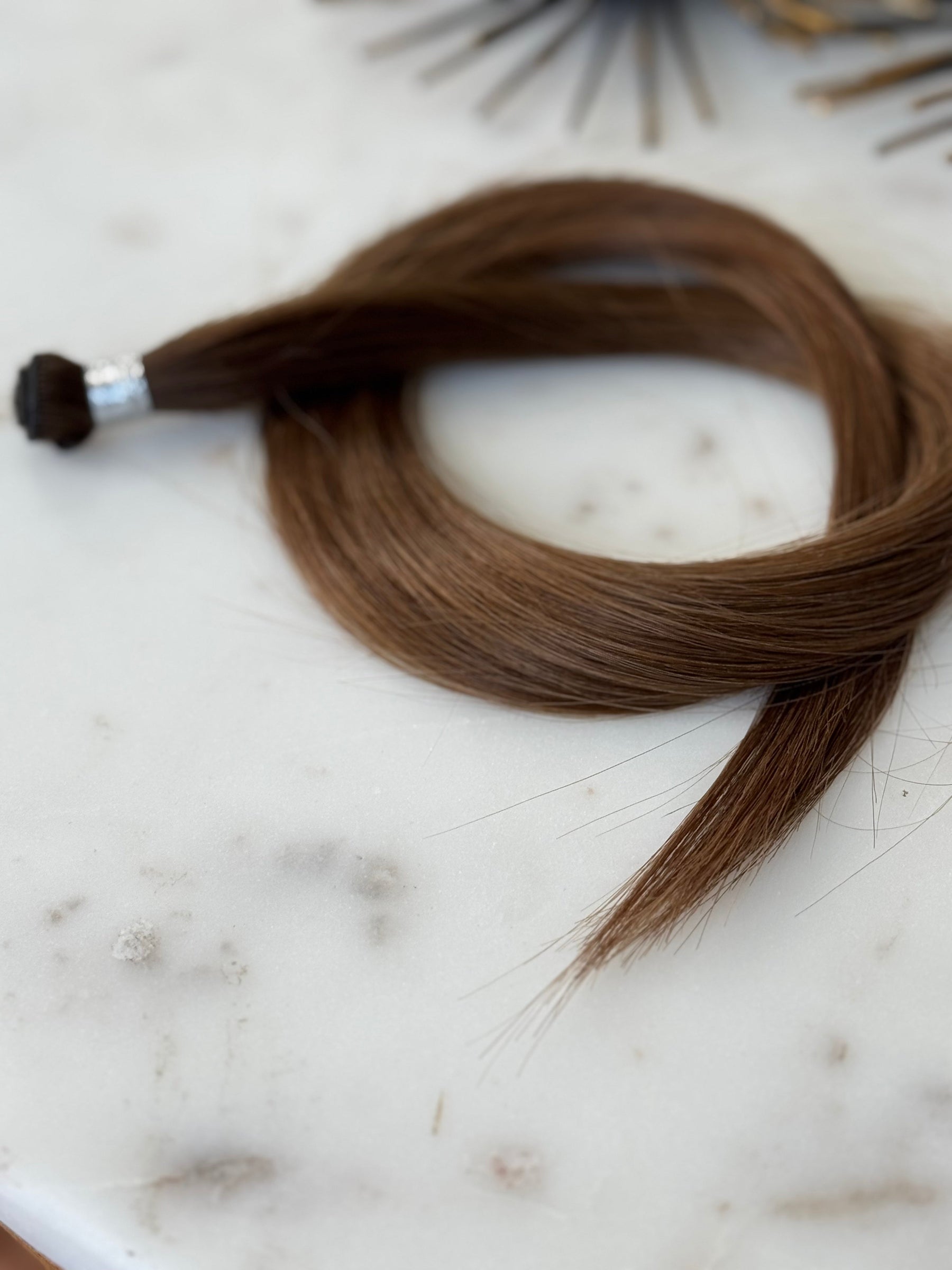 Soft-focus angled view of the Megan 20-inch hand-tied weft