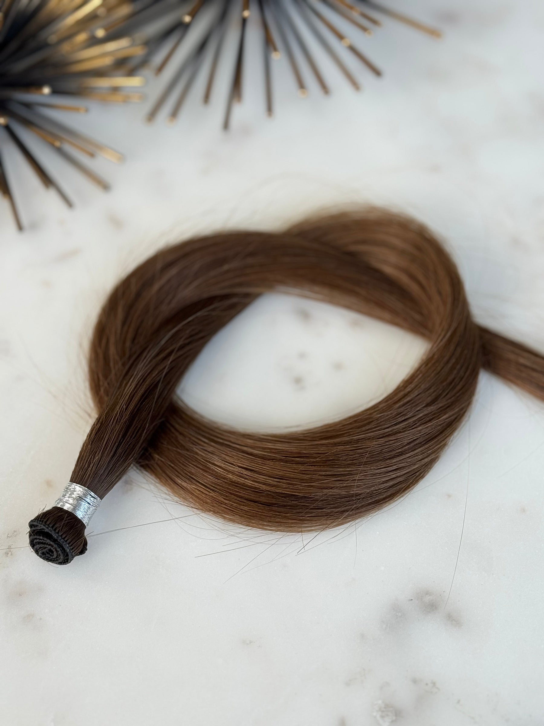 Megan 20-inch hand-tied weft showing the sewn base and hair length