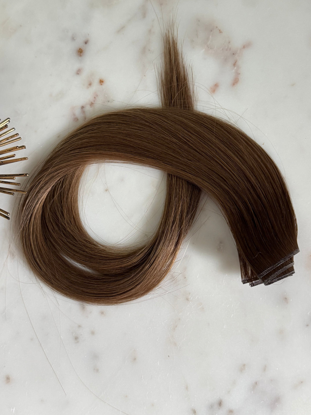 Megan Hybrid Weft 22-inch rooted brunette hair extension shown from above