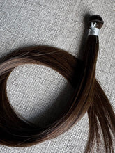 Load image into Gallery viewer, Detail view of the Rachele dark brown hand-tied hair extension weft seam and strands