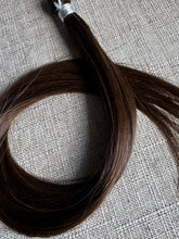 Load image into Gallery viewer, Close view of the Rachele dark brown hand-tied hair extension weft color and texture