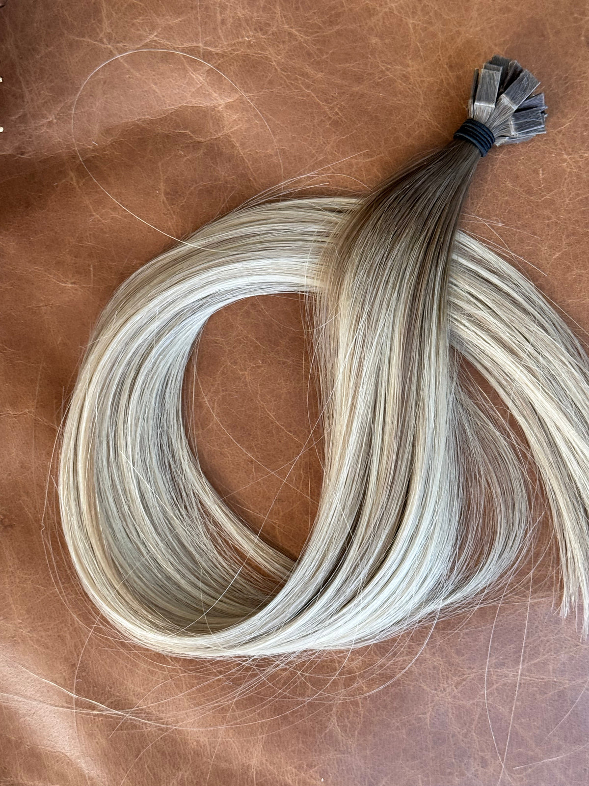 Sammy 18-inch K-tip hair extensions in rooted cool dirty blonde, full-length view